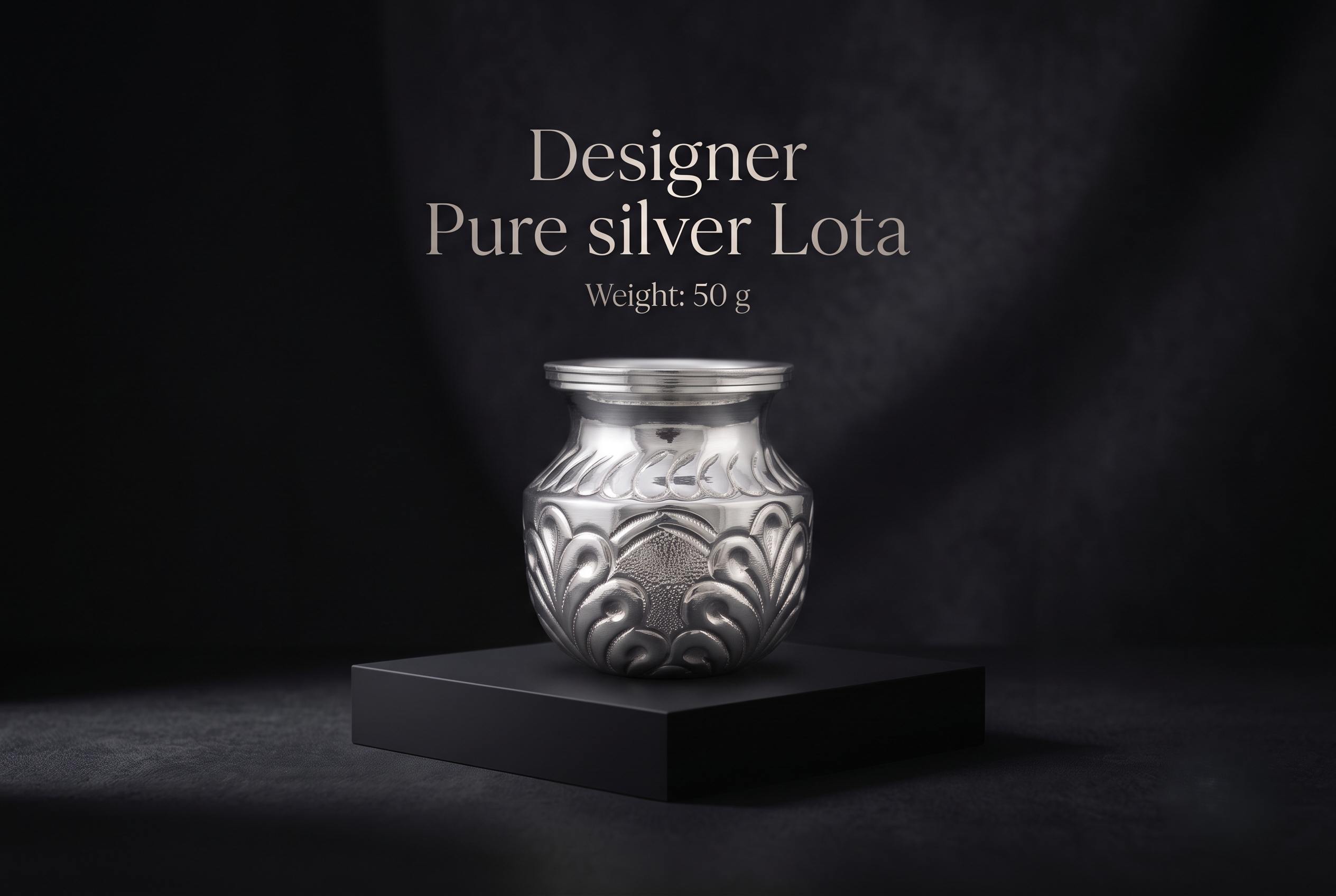 fancy-silver-lota-50gm A handcrafted 50g Designer Pure Silver Lota with intricate traditional engravings, displayed on a luxury matte black pedestal for premium pooja and gifting