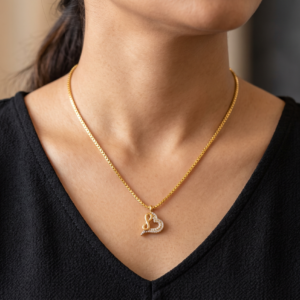 Rajyan Jewellers 18K gold Infinite Heart pendant and box chain lying on a luxury black velvet background