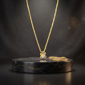 Close-up of Rajyan Jewellers 18 carat yellow gold butterfly pendant with sparkling Signity CZ central stones