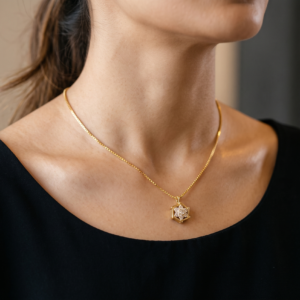 Natural lighting view of the 18ct gold box-link chain and hexagonal CZ star pendant
