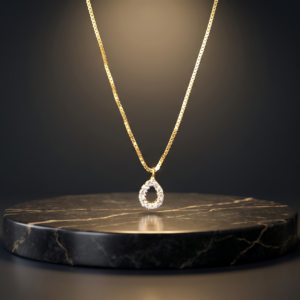 Luxury Rajyan Jewellers black and gold gift box containing an 18K gold drop pendant and chain set