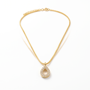Close-up of 18K yellow gold drop pendant with sparkling Signity CZ stones and gold chain links