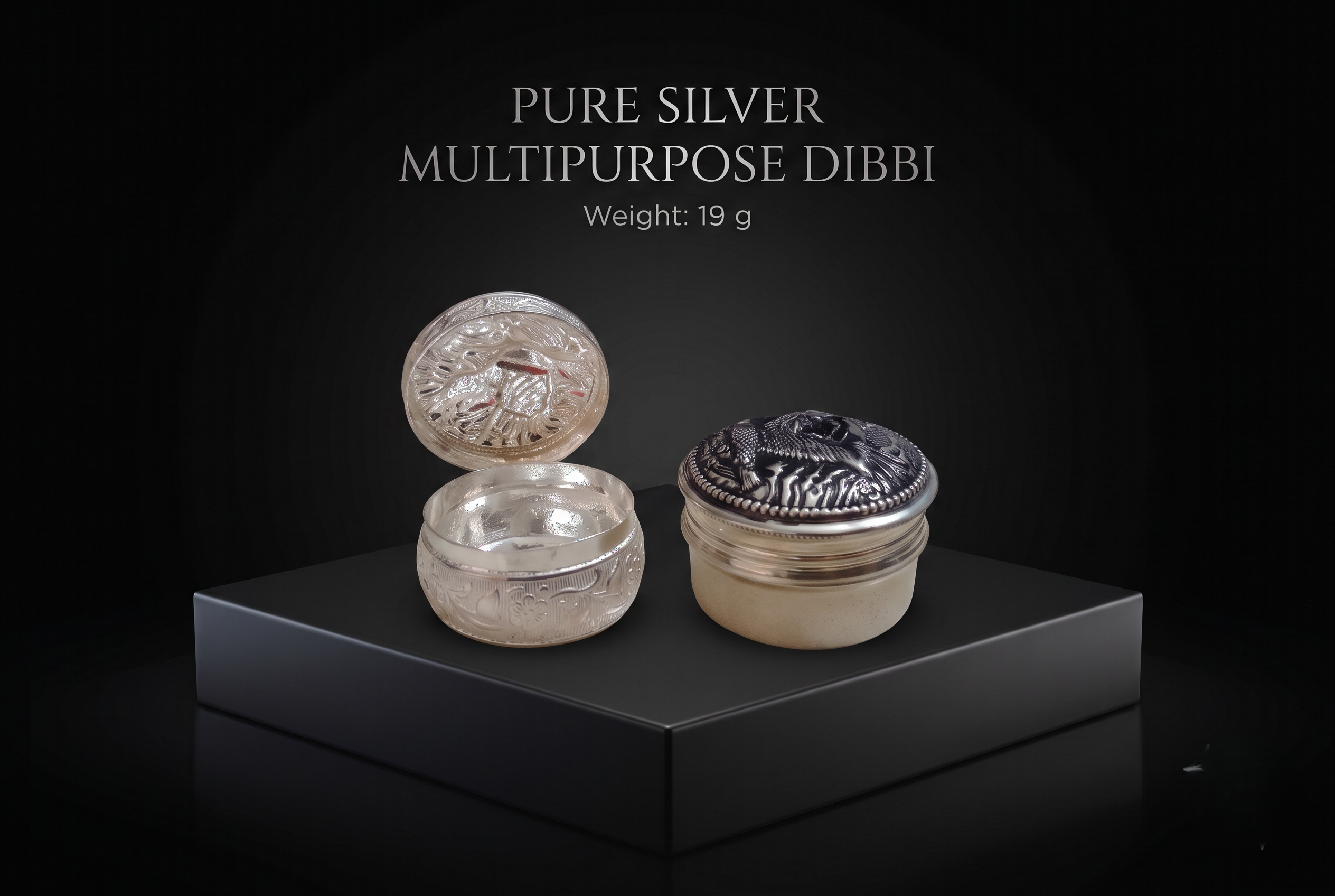 silver-dibbi-19gm Handcrafted 19g pure silver multipurpose dibbi showing open and closed lid with intricate bird engraving on matte black display