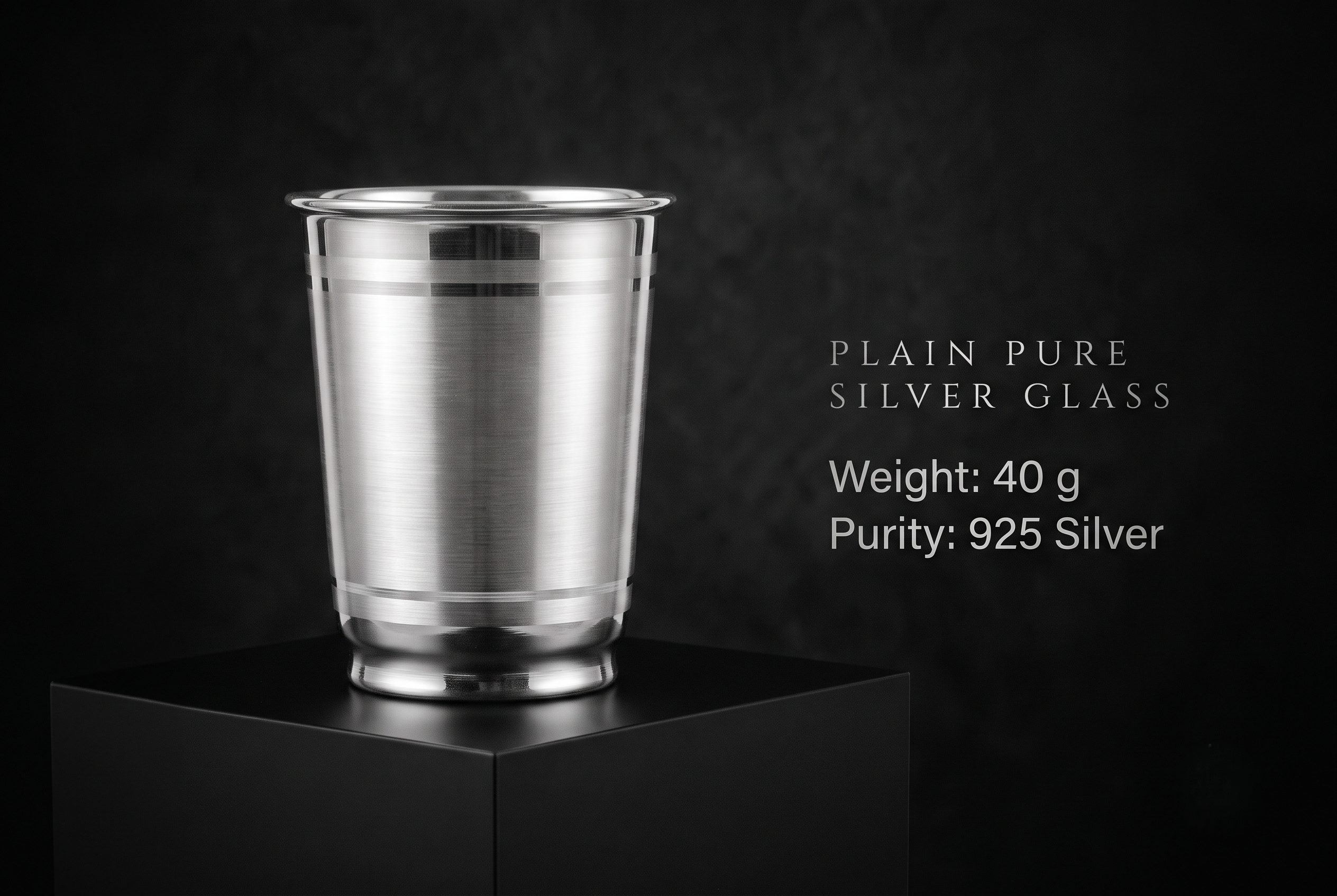 silver-glass-40gm Handcrafted 925 pure silver glass (40g) with a brushed metallic finish on a luxury matte black display, showing detailed horizontal stripe accents