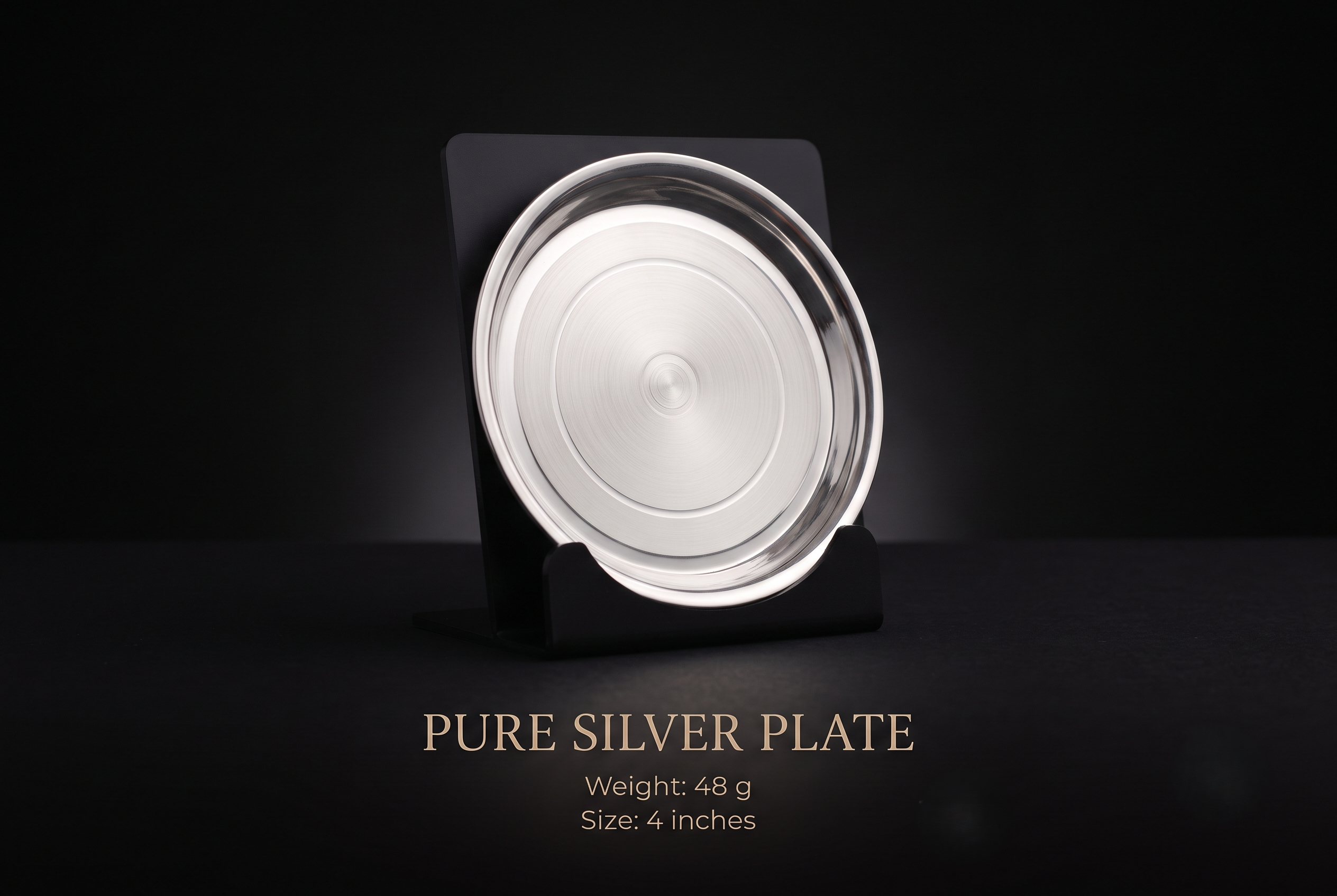 silver-plate-48gm Pure 4-inch silver plate weighing 48 grams displayed on a matte black acrylic stand
